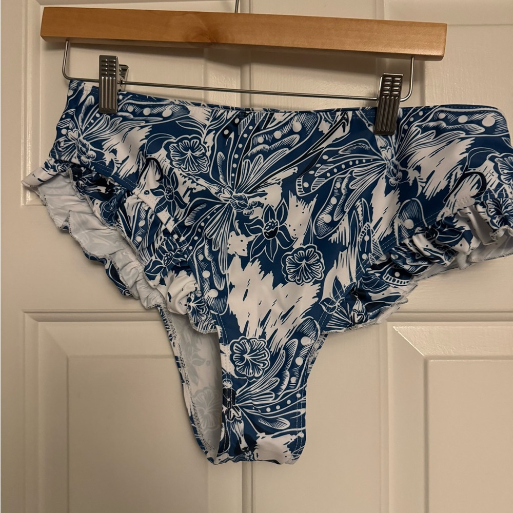 Blue and white floral print bikini bottom. Fun ruffles along the hips